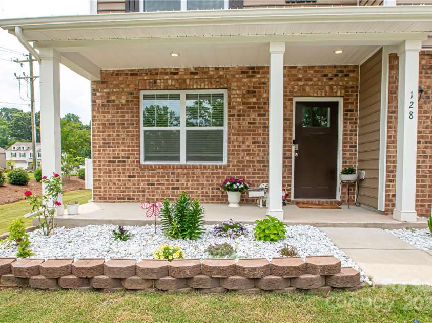 128 Hickory Ridge Drive, Locust, NC 28097.  MLS# CAR4270614, YatesRealty ID 21621. Enjoy the covered front porch and manicured yard!