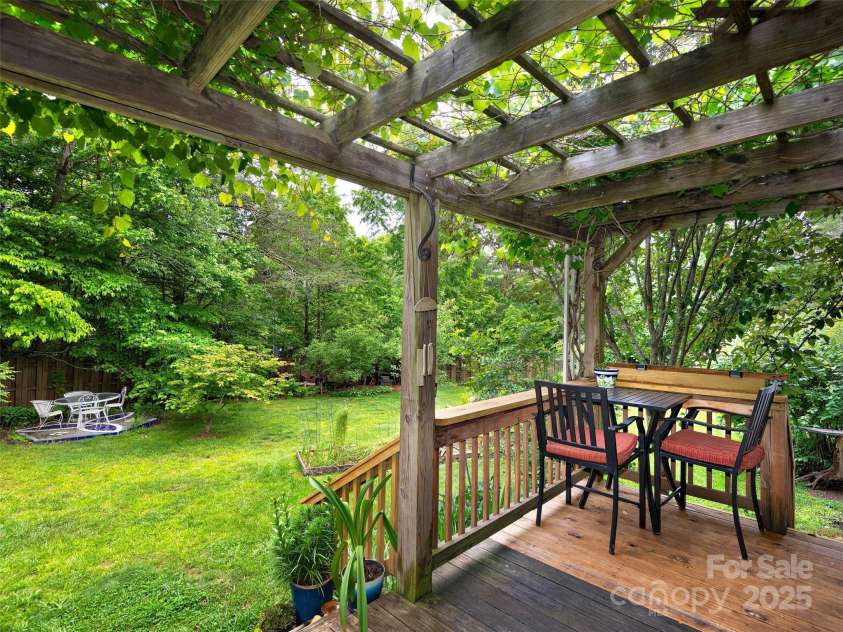 224 Old Haw Creek Road, Asheville, NC 28805.  MLS# CAR4259478, YatesRealty ID 21638. Deck outside Dining Area covered by a wisteria trellis.
