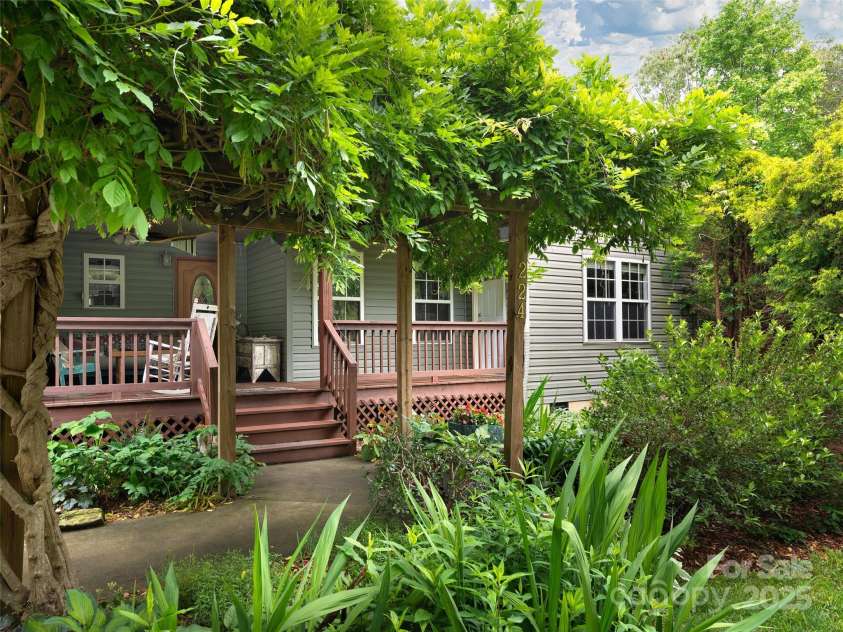 224 Old Haw Creek Road, Asheville, NC 28805.  MLS# CAR4259478, YatesRealty ID 21638. Summer Wisteria Trellis at Entrance