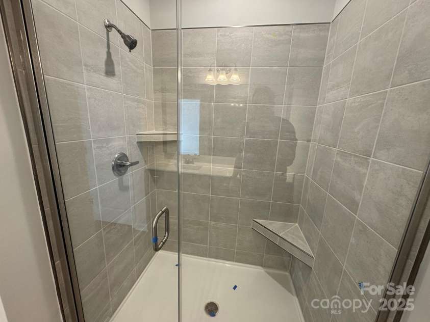 4750 Lakeview Road, Charlotte, NC 28216.  MLS# CAR4261325, YatesRealty ID 2164. Primary Bath Tile Shower with Semi-frameless glass door and tile wall