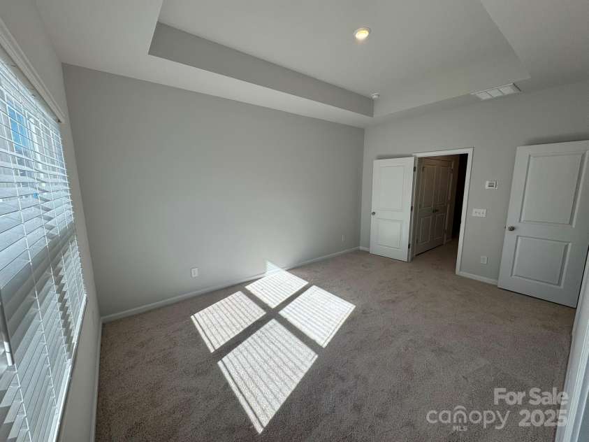 4750 Lakeview Road, Charlotte, NC 28216.  MLS# CAR4261325, YatesRealty ID 2164. Primary Bedroom with 10' boxed tray ceiling