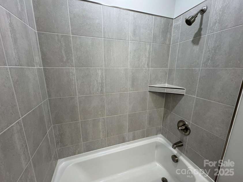 4750 Lakeview Road, Charlotte, NC 28216.  MLS# CAR4261325, YatesRealty ID 2164. Tile-wall at hall bath