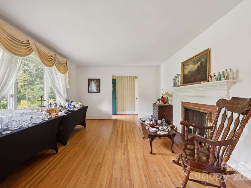 2500 Kendrick Drive, Charlotte, NC 28214.  MLS# CAR4269762, YatesRealty ID 21662. Living room with wood burning fireplace.