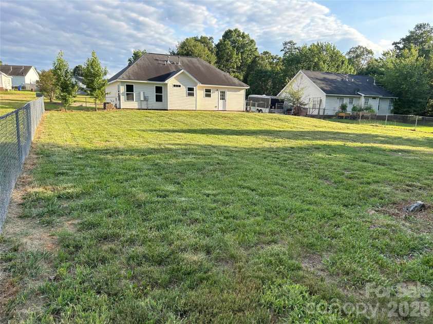 1002 Crescent Way, Wingate, NC 28174.  MLS# CAR4381075, YatesRealty ID 21672. Huge Rear Yard