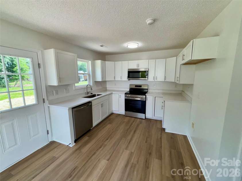 1002 Crescent Way, Wingate, NC 28174.  MLS# CAR4381075, YatesRealty ID 21672. Kitchen with New Quartz Counters, sink, faucet