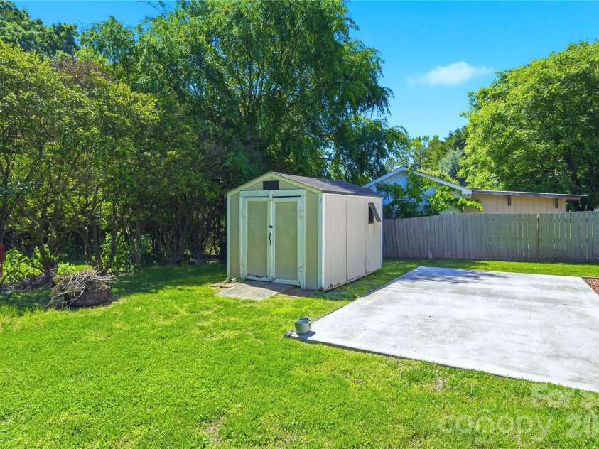 5701 Cedar Hill Drive, Wesley Chapel, NC 28110.  MLS# CAR4380517, YatesRealty ID 21674. Concrete pad next to garage and shed