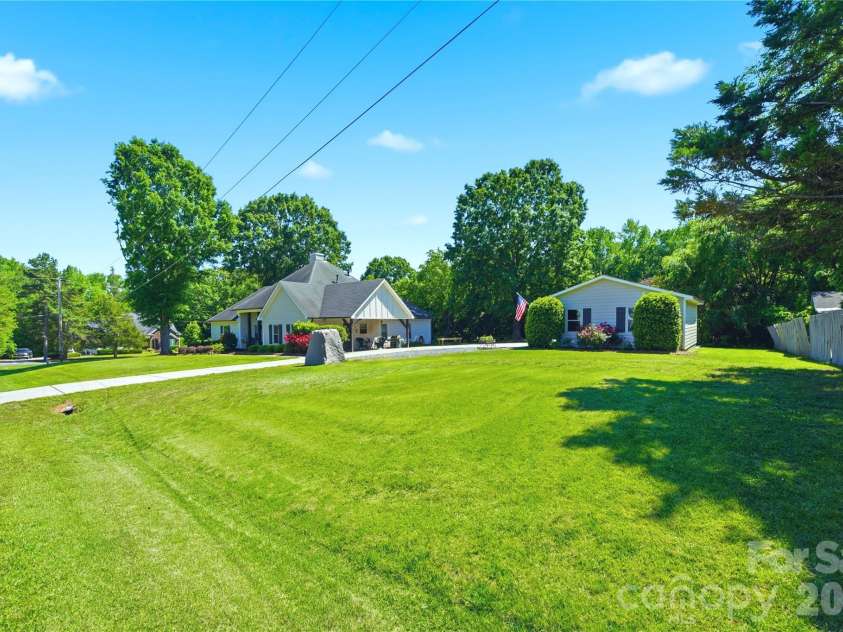 5701 Cedar Hill Drive, Wesley Chapel, NC 28110.  MLS# CAR4380517, YatesRealty ID 21674. Sweeping lawn and mature trees