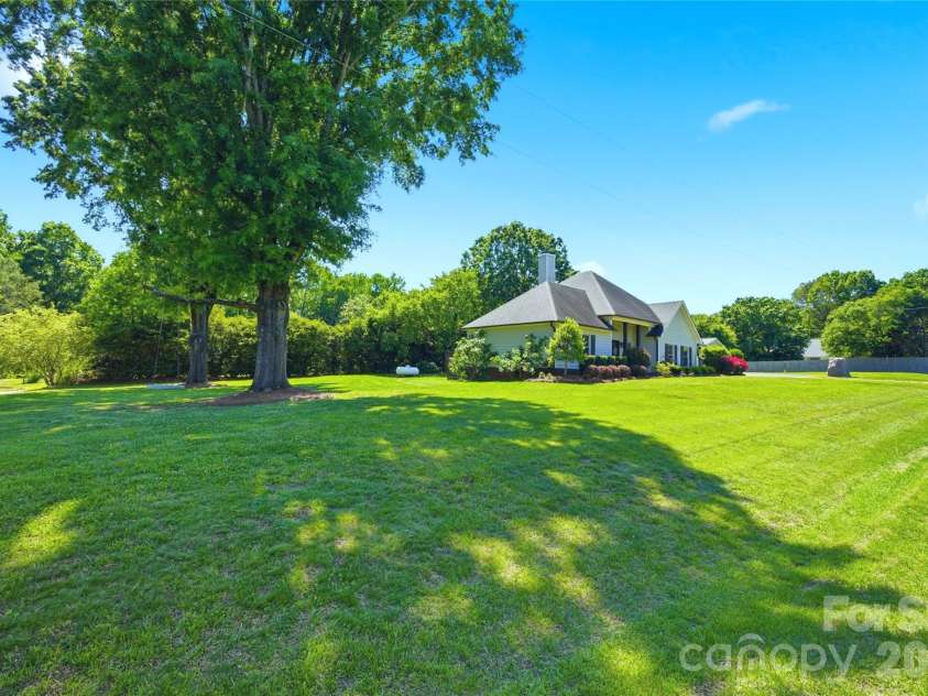 5701 Cedar Hill Drive, Wesley Chapel, NC 28110.  MLS# CAR4380517, YatesRealty ID 21674. Sweeping lawn and mature trees