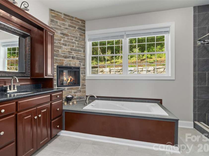 114 Nesting Ridge, Waynesville, NC 28785.  MLS# CAR4380539, YatesRealty ID 21695. Primary ensuite bath with soaking tub with electric fireplace