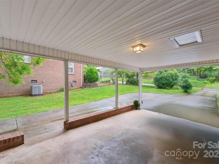 46 Donna Dale Avenue, Concord, NC 28025.  MLS# CAR4268171, YatesRealty ID 21700. Carport view of extra parking and driveway looking toward the street