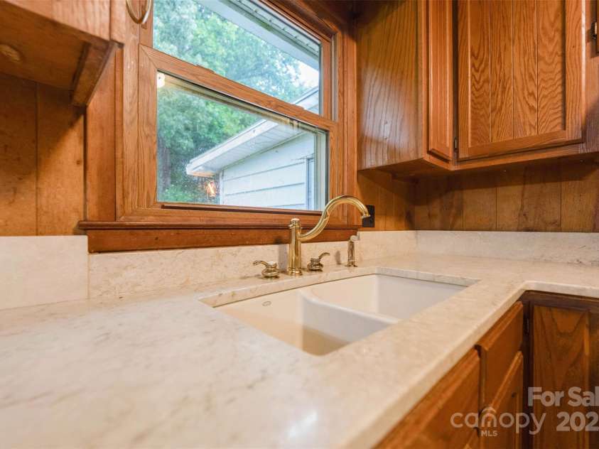 46 Donna Dale Avenue, Concord, NC 28025.  MLS# CAR4268171, YatesRealty ID 21700. Granite counter tops and gold faucet. Window over looks the back yard