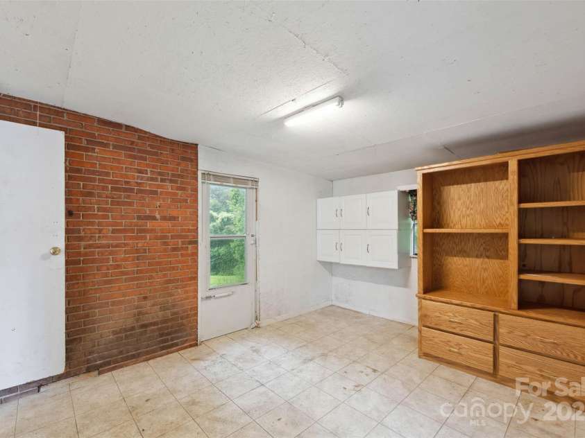 46 Donna Dale Avenue, Concord, NC 28025.  MLS# CAR4268171, YatesRealty ID 21700. Large storage area off the carport with door leading to the back yard