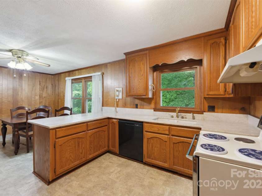 46 Donna Dale Avenue, Concord, NC 28025.  MLS# CAR4268171, YatesRealty ID 21700. View from the back door looking into the kitchen show casing the eat in dining area and bar