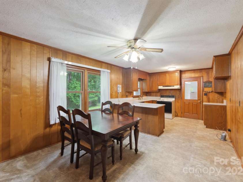 46 Donna Dale Avenue, Concord, NC 28025.  MLS# CAR4268171, YatesRealty ID 21700. View from the hallway looking into the kitchen. To the right is the washer and dryer hook up and the refrigerator area.
