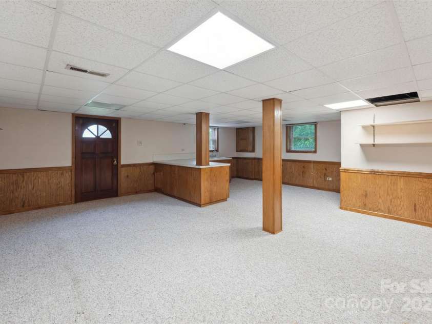 46 Donna Dale Avenue, Concord, NC 28025.  MLS# CAR4268171, YatesRealty ID 21700. View of basement from stairs and view of the basement door to back yard