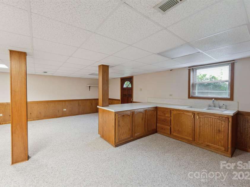 46 Donna Dale Avenue, Concord, NC 28025.  MLS# CAR4268171, YatesRealty ID 21700. View of cabinets, sink and bar area in the bsement