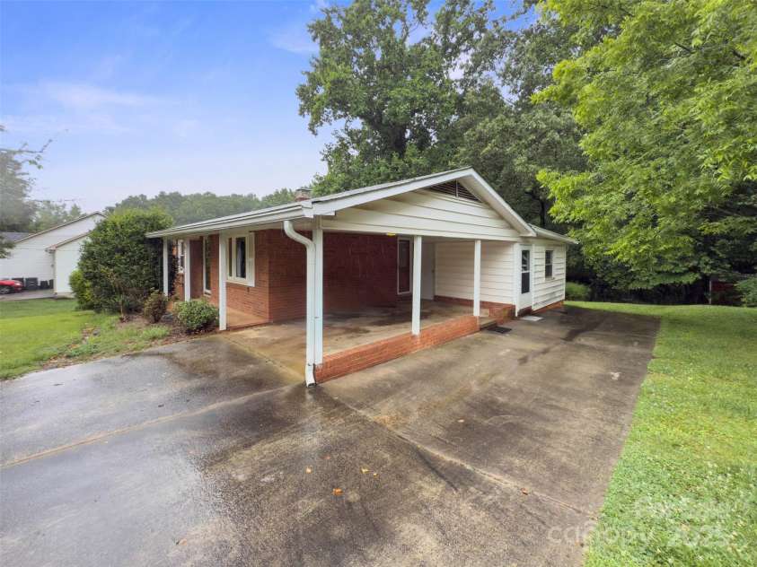 46 Donna Dale Avenue, Concord, NC 28025.  MLS# CAR4268171, YatesRealty ID 21700. View of extra parking area beside carport