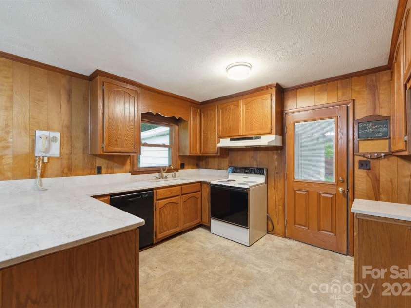 46 Donna Dale Avenue, Concord, NC 28025.  MLS# CAR4268171, YatesRealty ID 21700. View of the kitchen from the living room and show casing the back door that exits to the carport