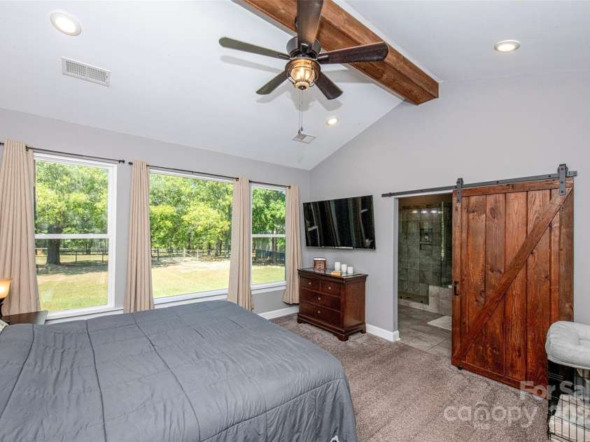 340 Hound Hollow Road, Camden, SC 29020.  MLS# CAR4240958, YatesRealty ID 21717. Primary Bedroom with Barn Door to Main Bath