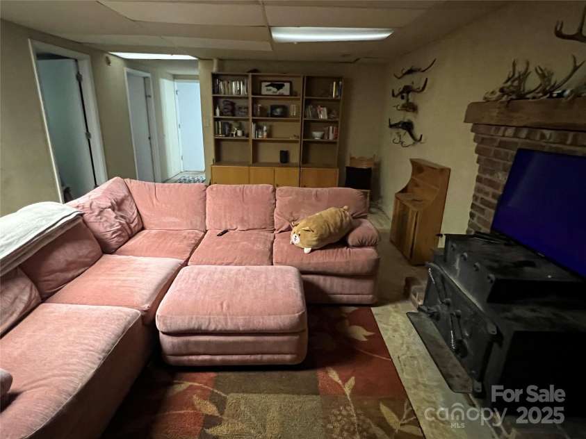 33611 Mann Road, Albemarle, NC 28001.  MLS# CAR4247905, YatesRealty ID 21759. Basement den with woodburning stove