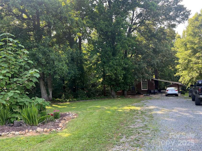 33611 Mann Road, Albemarle, NC 28001.  MLS# CAR4247905, YatesRealty ID 21759. House front, mid-driveway.