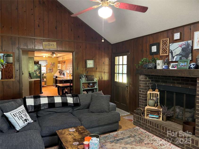 33611 Mann Road, Albemarle, NC 28001.  MLS# CAR4247905, YatesRealty ID 21759. View of living room view of fireplace to kitchen