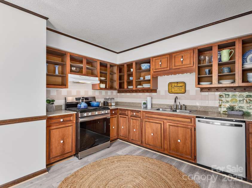 1469 Old Fort Road, Fairview, NC 28730.  MLS# CAR4240790, YatesRealty ID 21774. Beautiful finishes throughout the kitchen, tile backsplash and stainless steel appliances
