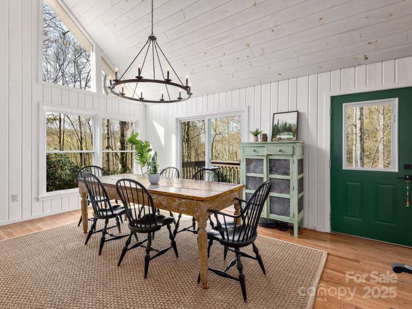 1469 Old Fort Road, Fairview, NC 28730.  MLS# CAR4240790, YatesRealty ID 21774. Bright dining area framed by multi-level windows with views of the surrounding forest