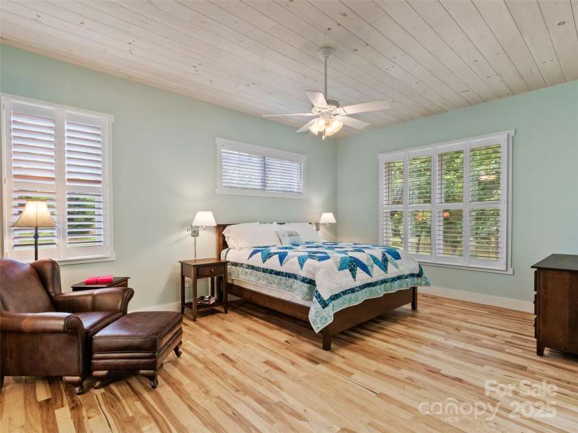 971 Banks Creek Road, Burnsville, NC 28714.  MLS# CAR4270100, YatesRealty ID 21780. A secondary primary suite with private entry to the covered porch and tranquil pond views