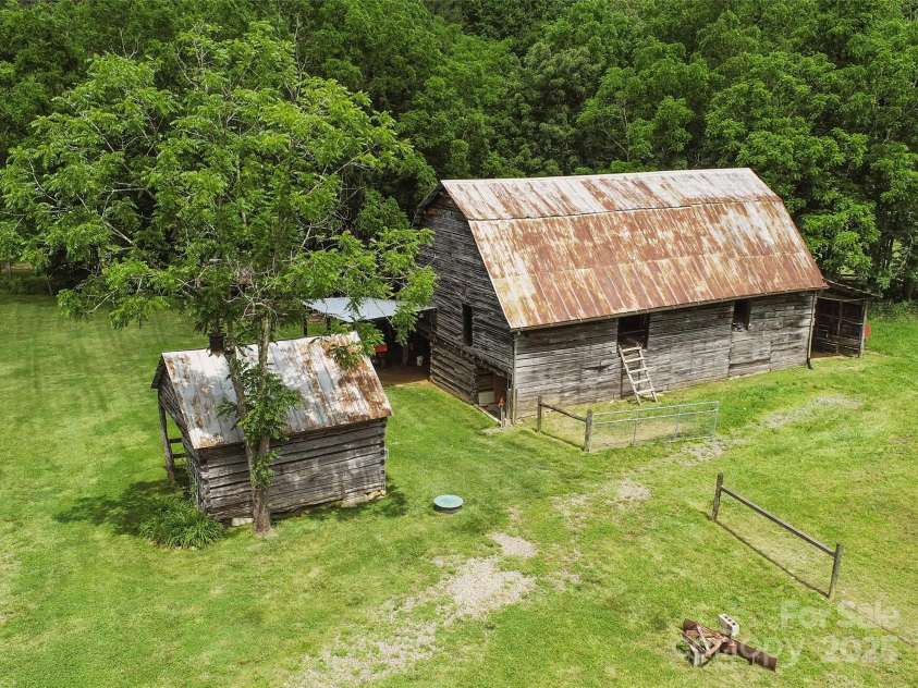 971 Banks Creek Road, Burnsville, NC 28714.  MLS# CAR4270100, YatesRealty ID 21780. Barn adjoins the paddock for seamless shelter and care of animals.