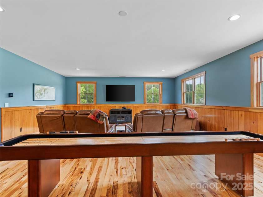 971 Banks Creek Road, Burnsville, NC 28714.  MLS# CAR4270100, YatesRealty ID 21780. Bathed in natural light, the upstairs game room is accented by warm hickory floors.