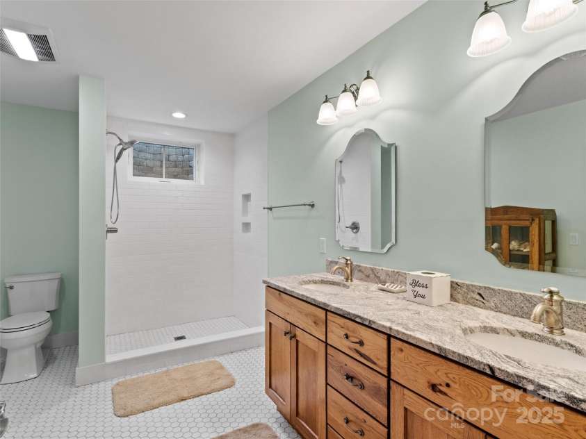 971 Banks Creek Road, Burnsville, NC 28714.  MLS# CAR4270100, YatesRealty ID 21780. Consistent with the home's refined style, the basement bathroom is equally elegant and well-appointed.