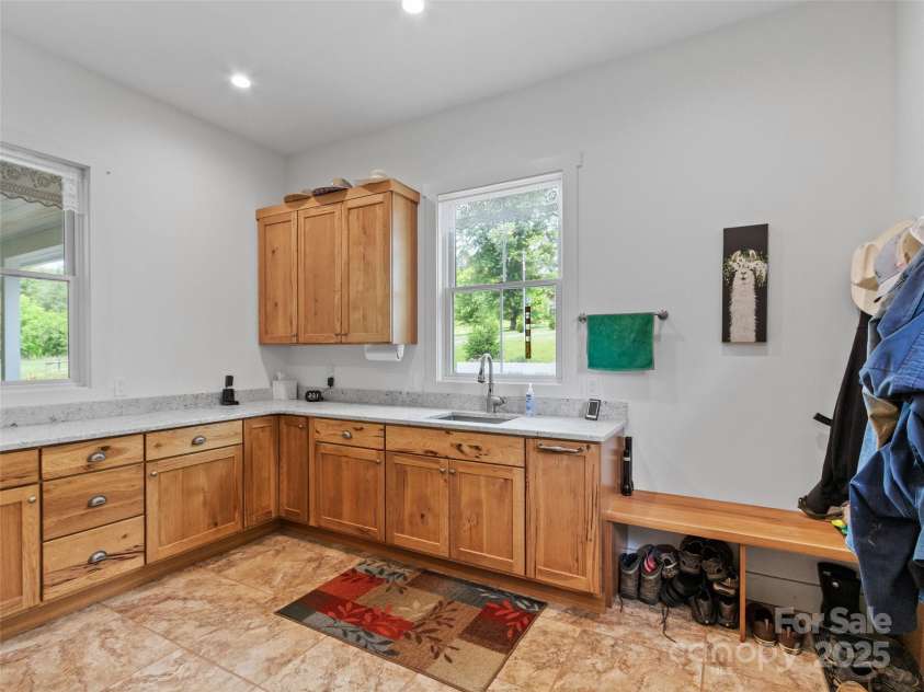 971 Banks Creek Road, Burnsville, NC 28714.  MLS# CAR4270100, YatesRealty ID 21780. Custom cabinetry provides ample additional storage, complemented by a convenient wash sink