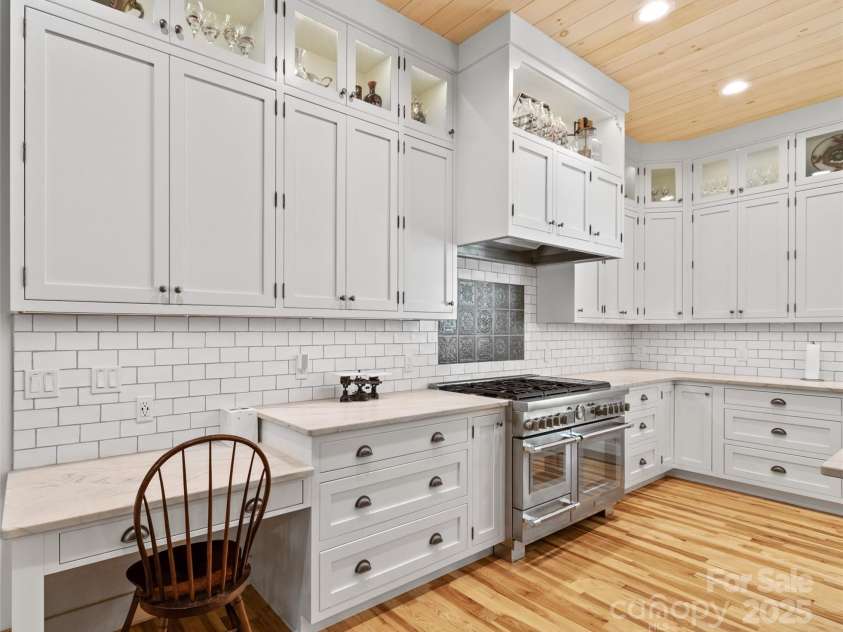 971 Banks Creek Road, Burnsville, NC 28714.  MLS# CAR4270100, YatesRealty ID 21780. Equipped with a gourmet Thermador triple-fuel range, enduring subway tile design, and a thoughtfully placed writing desk.
