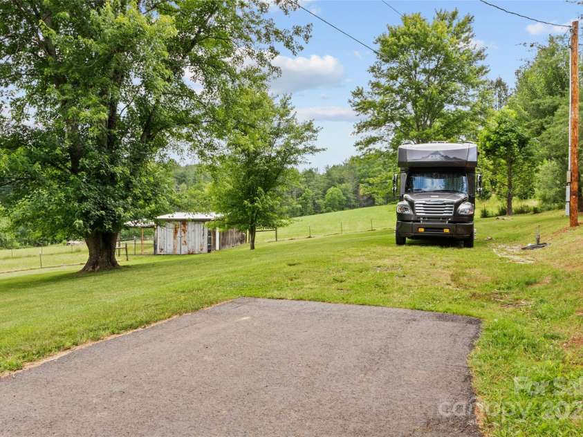 971 Banks Creek Road, Burnsville, NC 28714.  MLS# CAR4270100, YatesRealty ID 21780. Includes a dedicated RV site with full hookups, offering flexibility for personal stays or as a rentable storage option