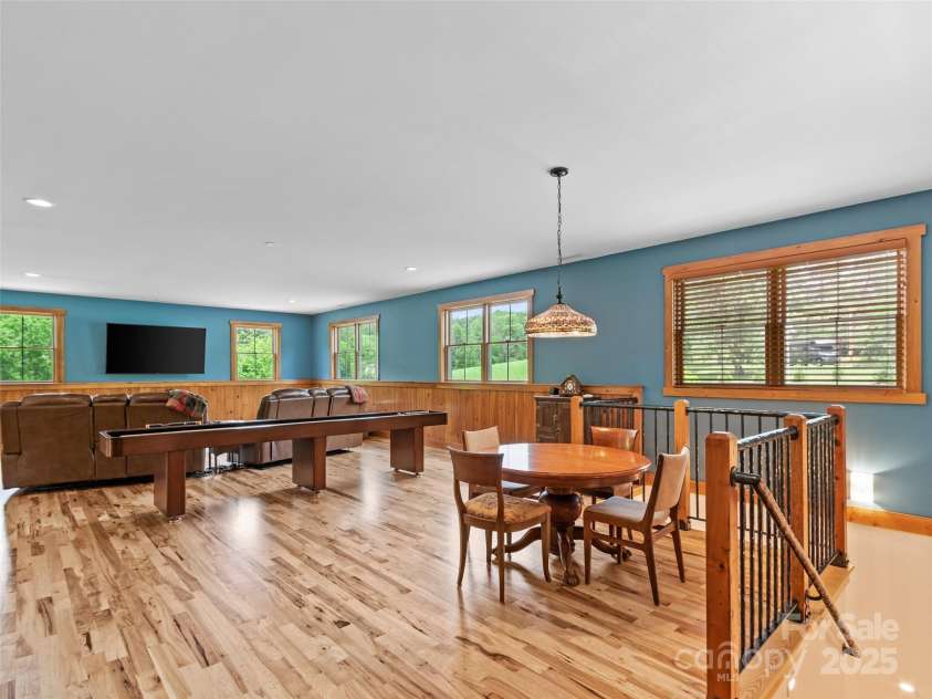 971 Banks Creek Road, Burnsville, NC 28714.  MLS# CAR4270100, YatesRealty ID 21780. Upstairs you'll find a generous game room and an artisan-crafted iron railing, a unique touch by a local craftsman