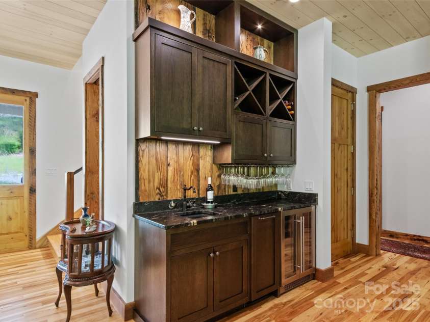 971 Banks Creek Road, Burnsville, NC 28714.  MLS# CAR4270100, YatesRealty ID 21780. Well-appointed custom wet bar featuring an ice maker, beverage fridge, and dedicated wine storage.