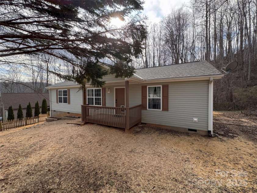 231 Newberry Drive, Fletcher, NC 28732.  MLS# CAR4221734, YatesRealty ID 21787. Wooded area behind the home