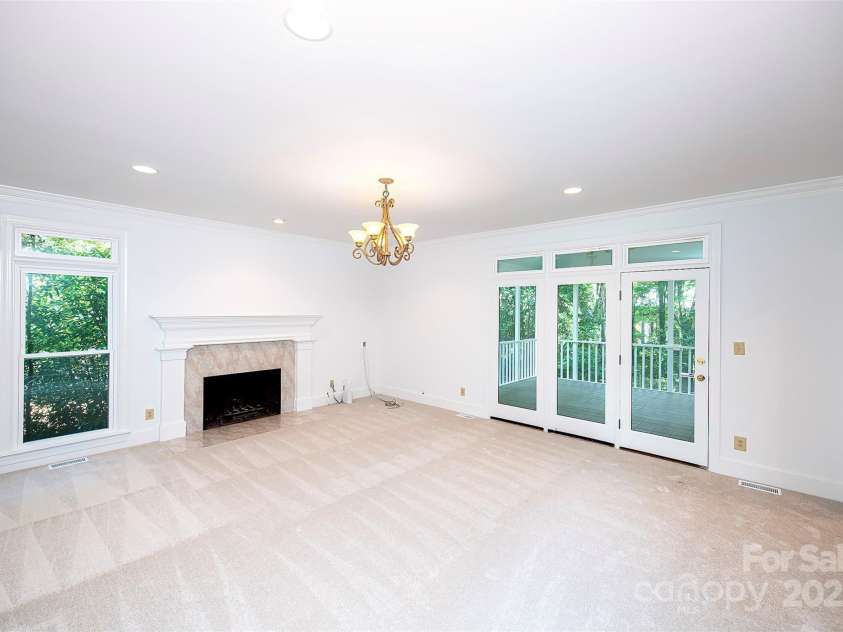 10408 Hadleigh Place, Charlotte, NC 28210.  MLS# CAR4270880, YatesRealty ID 21794. Large family room with wood burning fireplace but gas logs are in the garage.  Opens to a wonderful screened porch with vaulted ceiling.