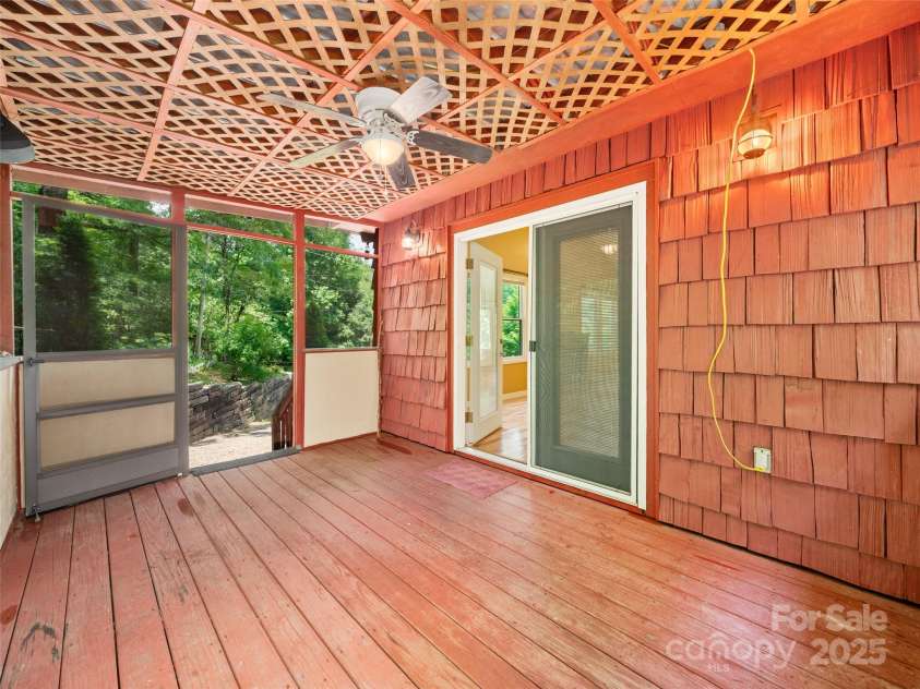 125 Heartland Lane, Burnsville, NC 28714.  MLS# CAR4273356, YatesRealty ID 21808. Screened back porch entrance from driveway.