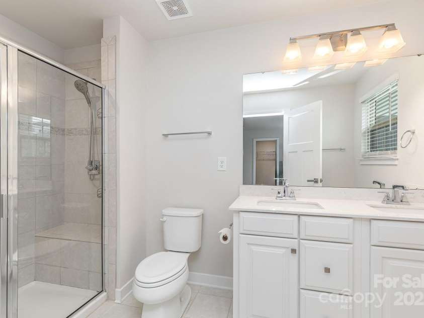 138 Lanyard Drive, Mooresville, NC 28117.  MLS# CAR4260575, YatesRealty ID 21810. Ensuite includes modern vanity and lighting