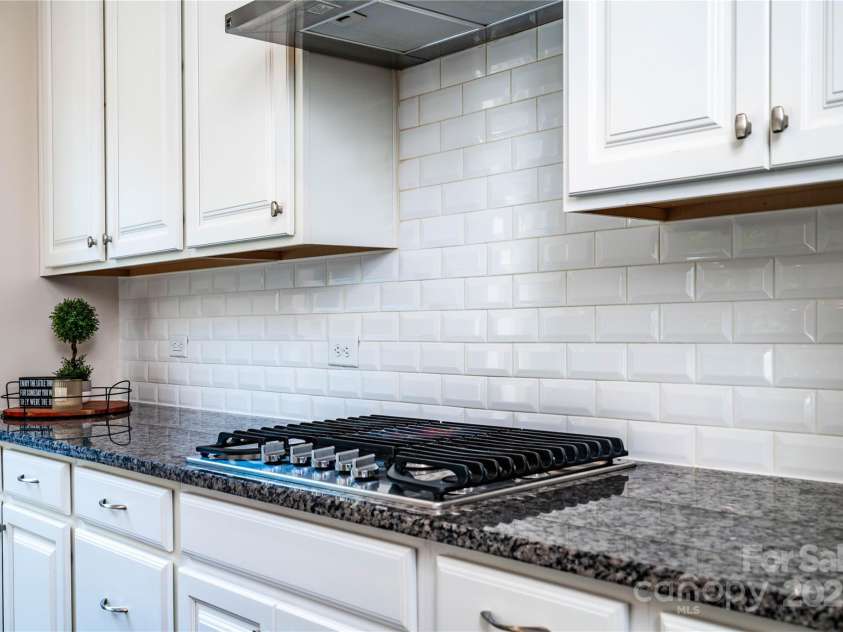 203 Rustling Waters Drive, Mooresville, NC 28117.  MLS# CAR4266533, YatesRealty ID 21811. Gas cooktop with vent hood