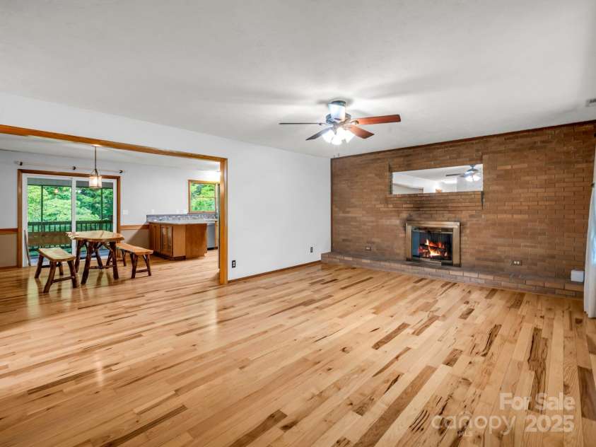 989 Mine Gap Road, Zirconia, NC 28790.  MLS# CAR4264634, YatesRealty ID 21834. Living room view into dining and kitchen