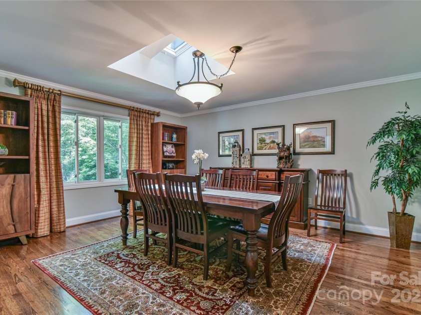 409 North Fork Road, Black Mountain, NC 28711.  MLS# CAR4284708, YatesRealty ID 2185. The dining room greets guests as they enter the front door. Skylights provide natural light throughout. 