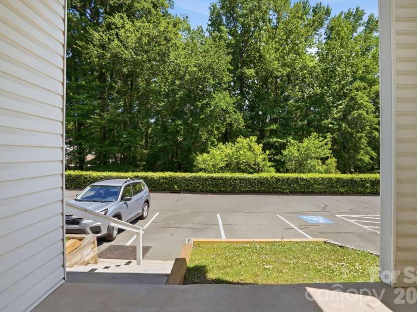 19762 Feriba Place, Cornelius, NC 28031.  MLS# CAR4378752, YatesRealty ID 21850. Back patio - view of parking area.