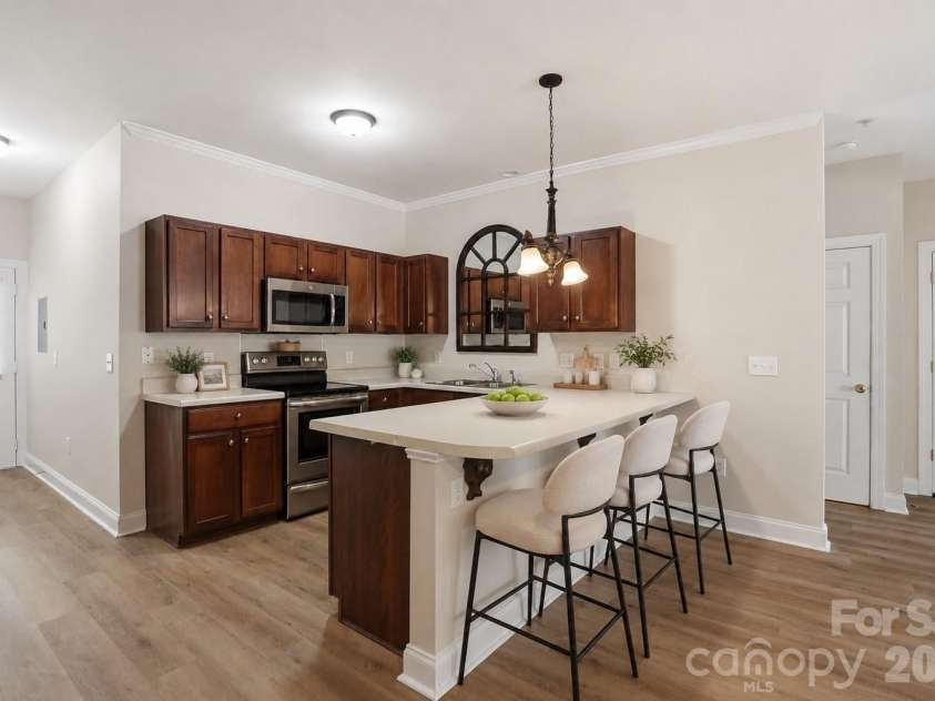 19762 Feriba Place, Cornelius, NC 28031.  MLS# CAR4378752, YatesRealty ID 21850. Kitchen with bar and plenty of cabinets - virtually staged.