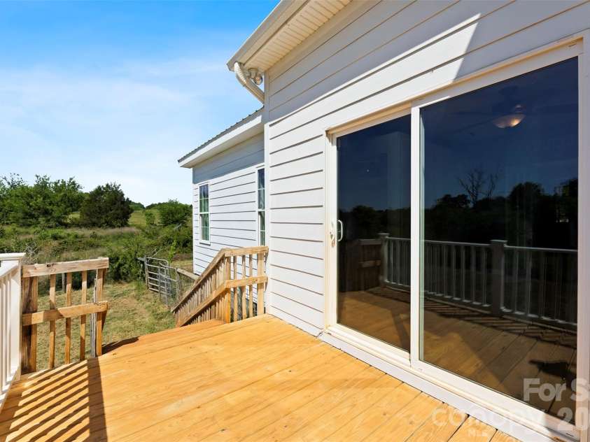 1205 French Belk Road, Mt Ulla, NC 28125.  MLS# CAR4377325, YatesRealty ID 21866. Private deck off laundry and primary wing