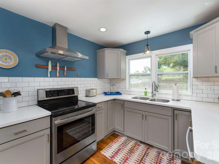 477 Emma Road, Asheville, NC 28806.  MLS# CAR4378114, YatesRealty ID 21881. This kitchen! Fully updated and as pretty as it is functional