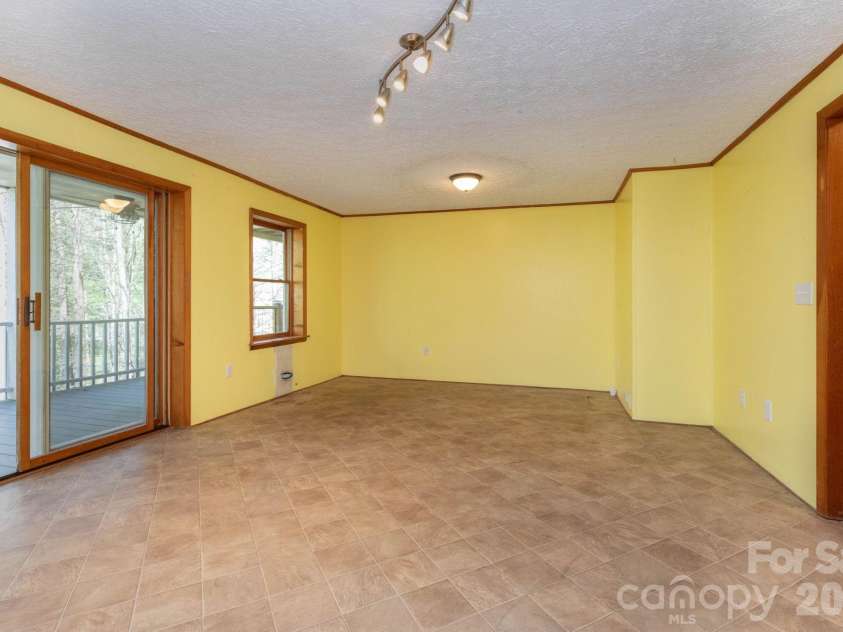 87 Medley Drive, Waynesville, NC 28785.  MLS# CAR4375332, YatesRealty ID 21884. Lower Level Living Room