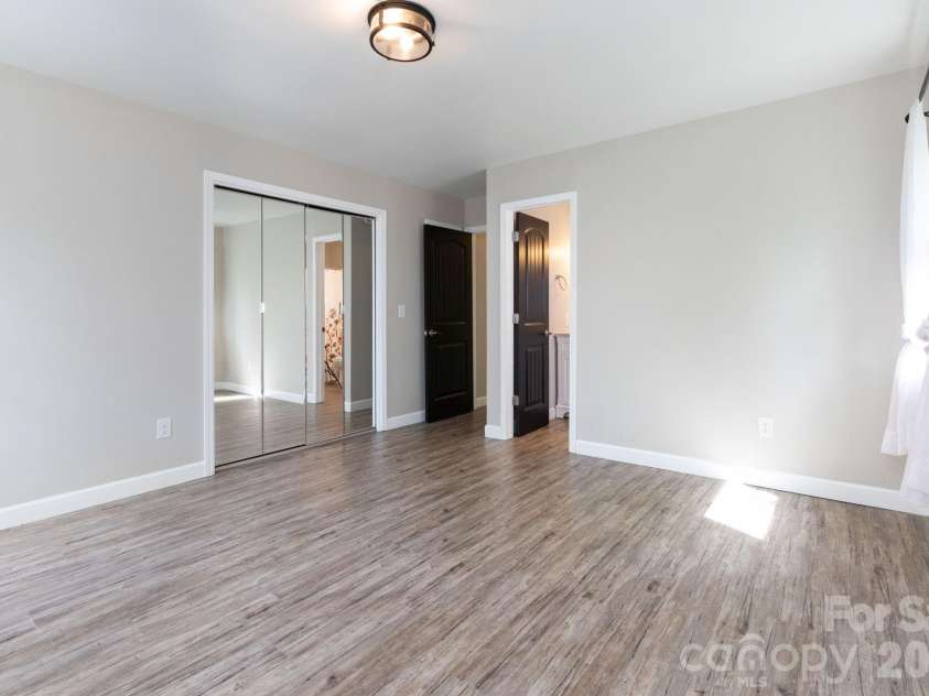 87 Medley Drive, Waynesville, NC 28785.  MLS# CAR4375332, YatesRealty ID 21884. Main Level Primary Bedroom